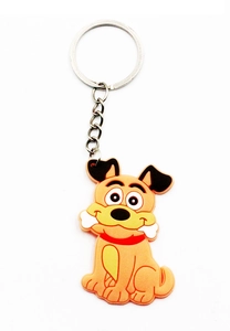 Close-up of PVC forest animal keychain with orange dog holding a bone on white background