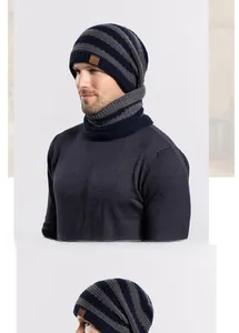 Detail of navy and grey knitted beanie with warm fleece lining and sport leather tag