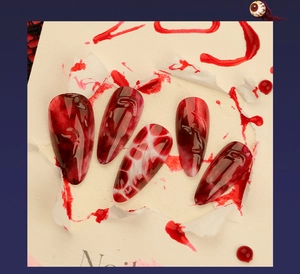 Detailed view of Halloween almond press-on nails with 3D red blood marble art design