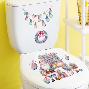 Pink Santa and reindeer Christmas wreath decals on a white ceramic toilet cover