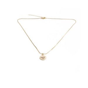 Detailed close-up of golden cross and evil eye pendant necklace with cubic zirconia