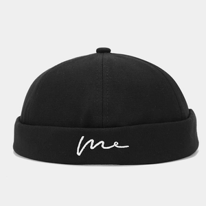 Close-up of white 'me' embroidery on black canvas docker hat with wave stitching details