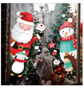 Detail of Christmas window stickers featuring Santa and snowman with a warm holiday backdrop