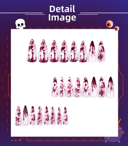 Detail of Halloween stiletto press-on nails with red splatter design and long sharp tips