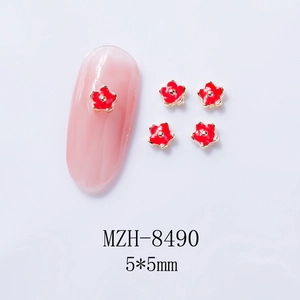 Macro view of MZH-8490 5x5mm red flower nail charms with golden base and enamel finish