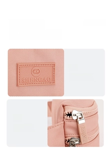 Close-up of pink oxford waist bag showing SHENGAO rubber logo and JingPin metal zipper detail