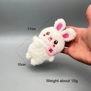 Close-up of white plush bunny keychain with cherry bag, measuring 17cm in height