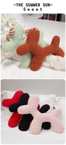 Detail of soft teddy velvet cartoon dog plush pillow showing fluffy texture and colors