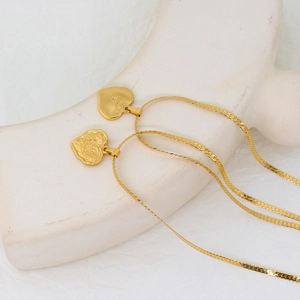 Golden heart pendant necklace with textured letter Z on an elegant snake chain