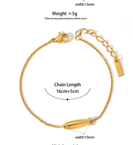 Detail of golden fish bracelet with small diamond inlay and adjustable lobster clasp closure