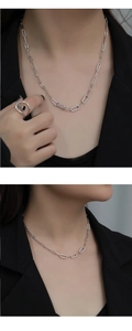 Detail of 925 sterling silver chunky oval link necklace with pavé zircon stones on model