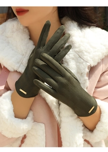 Detail of dark green suede winter gloves for women with a gold FASHION metal label