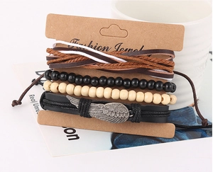 Close-up of multilayer woven bracelets with metal wing charm on a display card