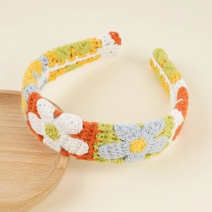 Detail of bohemian floral crochet headband with colorful hand-knitted daisy patterns