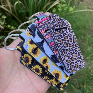 Detailed view of four neoprene lipstick holders with leopard and sunflower prints