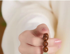 Macro shot of natural golden Phoebe wood beads showing fine texture and grain details