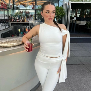 Close-up of white off-shoulder tie-up top and matching leggings in stretch fabric