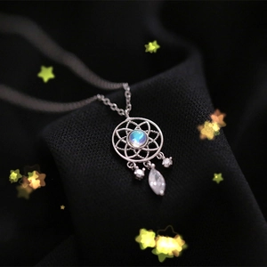 Macro shot of silver dreamcatcher necklace pendant with moonstone and starlight effects