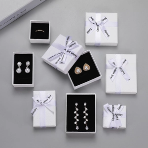 Various white litchi pattern jewelry boxes with black flocking lining and silk ribbon