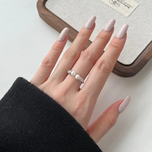 Detail of S925 silver ring featuring twin white pearls and sparkling zircon accents