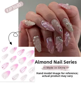 Detail of 3D pink gradient almond press-on nails with pearl and rhinestone shell design