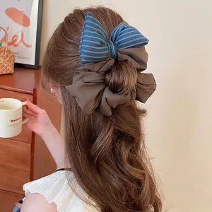 Elegant fabric puff bow scrunchie with blue stripes and brown pleated details