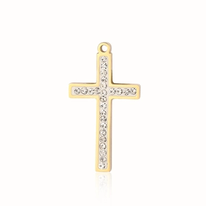 Detail of a golden cross pendant with sparkling clear crystals on a white background