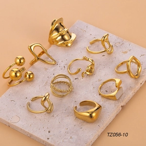 Set of 10 vintage gold geometric stainless steel rings displayed on stone