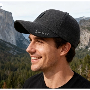 Detail of dark grey wool winter baseball cap with white Down the street embroidery