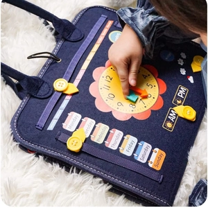 Montessori busy board for kids featuring felt clock and calendar learning tools