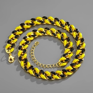 Close-up of dual-tone gold and black cuban link necklace with secure lobster clasp