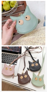 Detail of four colorful cat-shaped PU leather coin purses with lanyards and zippers