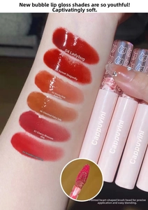 Detailed swatches of mirror finish lip glaze showing six shades and heart shaped brush head