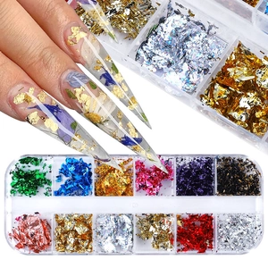Detail of 12-color nail art foil flakes in a storage box with manicured nail example