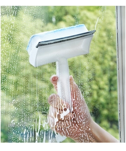 Manual window squeegee cleaning a soapy glass surface with high-density sponge and scraper