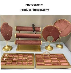 Detailed set of red velvet and gold metal jewelry stands for necklaces and bracelets