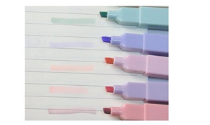 Close-up of pastel highlighters with chisel tips showing color swatches on paper