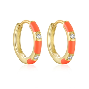 Detail of gold huggie earrings with orange enamel and clear crystal stone inlays
