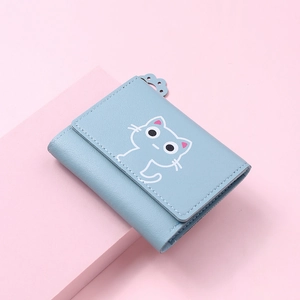 Close-up of light blue trifold cat wallet with cat paw zipper on pink background