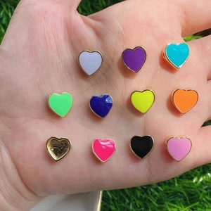 Macro shot of colorful enamel heart charms on metal base for DIY jewelry making