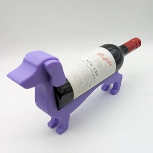 Close-up of a purple dachshund wine bottle holder with a smooth finish on white background