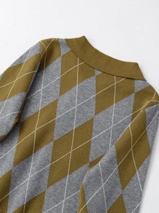 Detail of olive green argyle knit sweater with ribbed neckline and premium texture