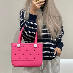 Close-up of rose pink EVA beach tote showing breathable holes and white buckle detail