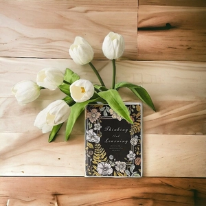 Detailed view of book-shaped ceramic vase featuring Thinking and Learning floral design