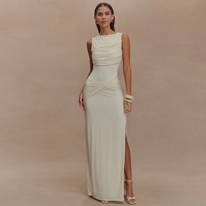 Detail of elegant white sleeveless dress featuring unique pleated texture and side slit