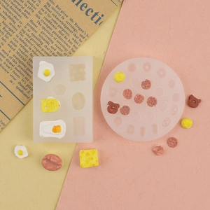 DIY silicone molds for miniature food like donuts and cheese on a vintage background