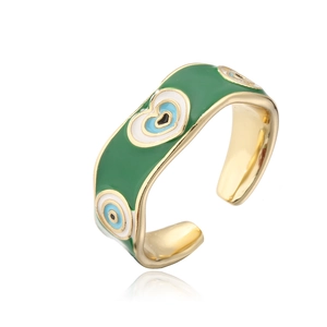 Detailed macro view of 18K gold plated ring featuring green enamel and Evil Eye heart pattern