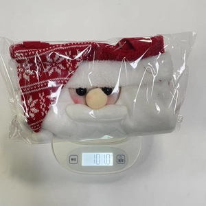 Digital scale showing the 101.0g weight of a Santa Claus themed Christmas gift bag