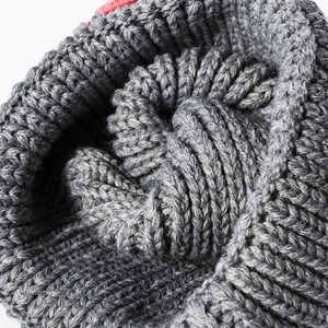 Winter chunky knit beanie in grey featuring warm ear protection and thick wool texture
