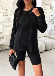 Detail of black ribbed knit long-sleeved top and tight shorts set with vertical texture